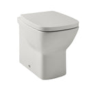 A white, wall-mounted toilet with a closed lid, designed for modern bathrooms.