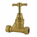 A gold-colored brass stopcock valve with a C-shaped body and a curved handle.